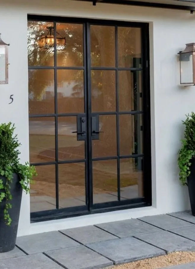 Divided-light black steel double front doors with modern pull handles