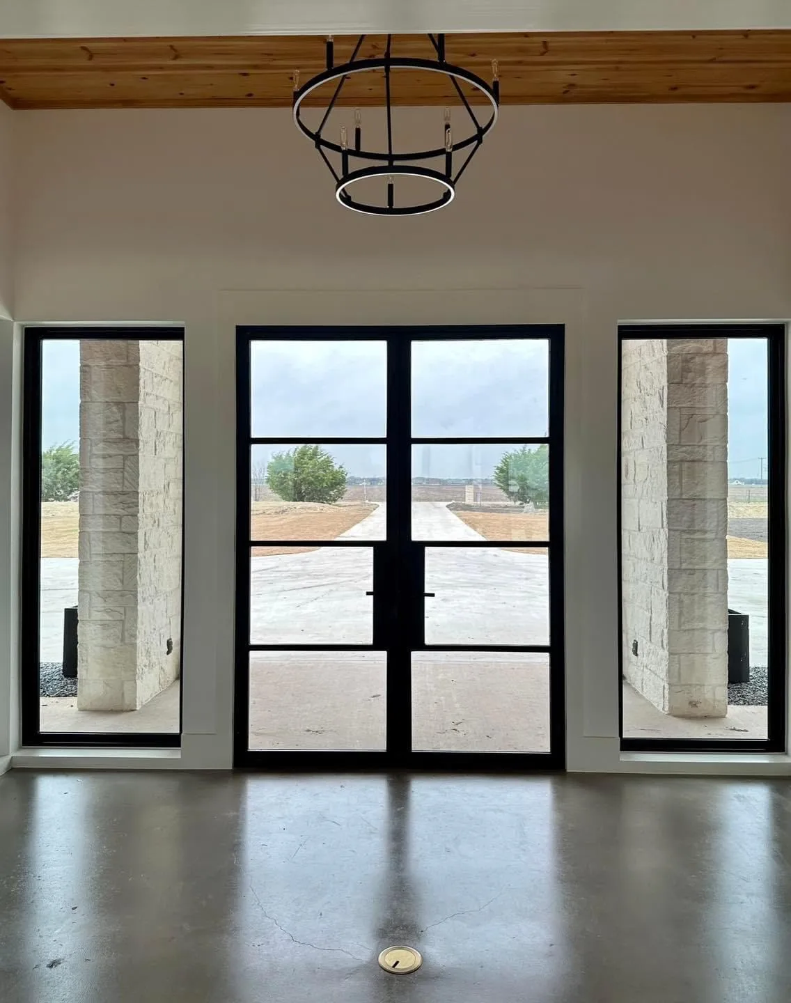 Black steel French doors with matching full-height glass sidelights