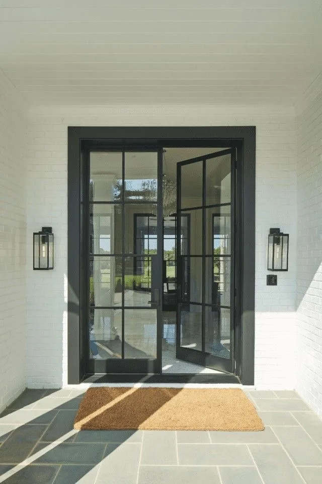 Custom open steel French double doors connecting indoor and outdoor spaces