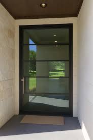 Modern pivot door with slim dark framing and premium pull hardware