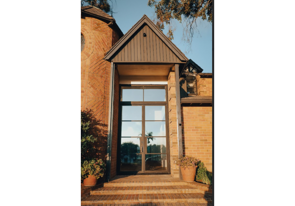 Steel entry door with transom window in Austin TX for taller modern front entrance