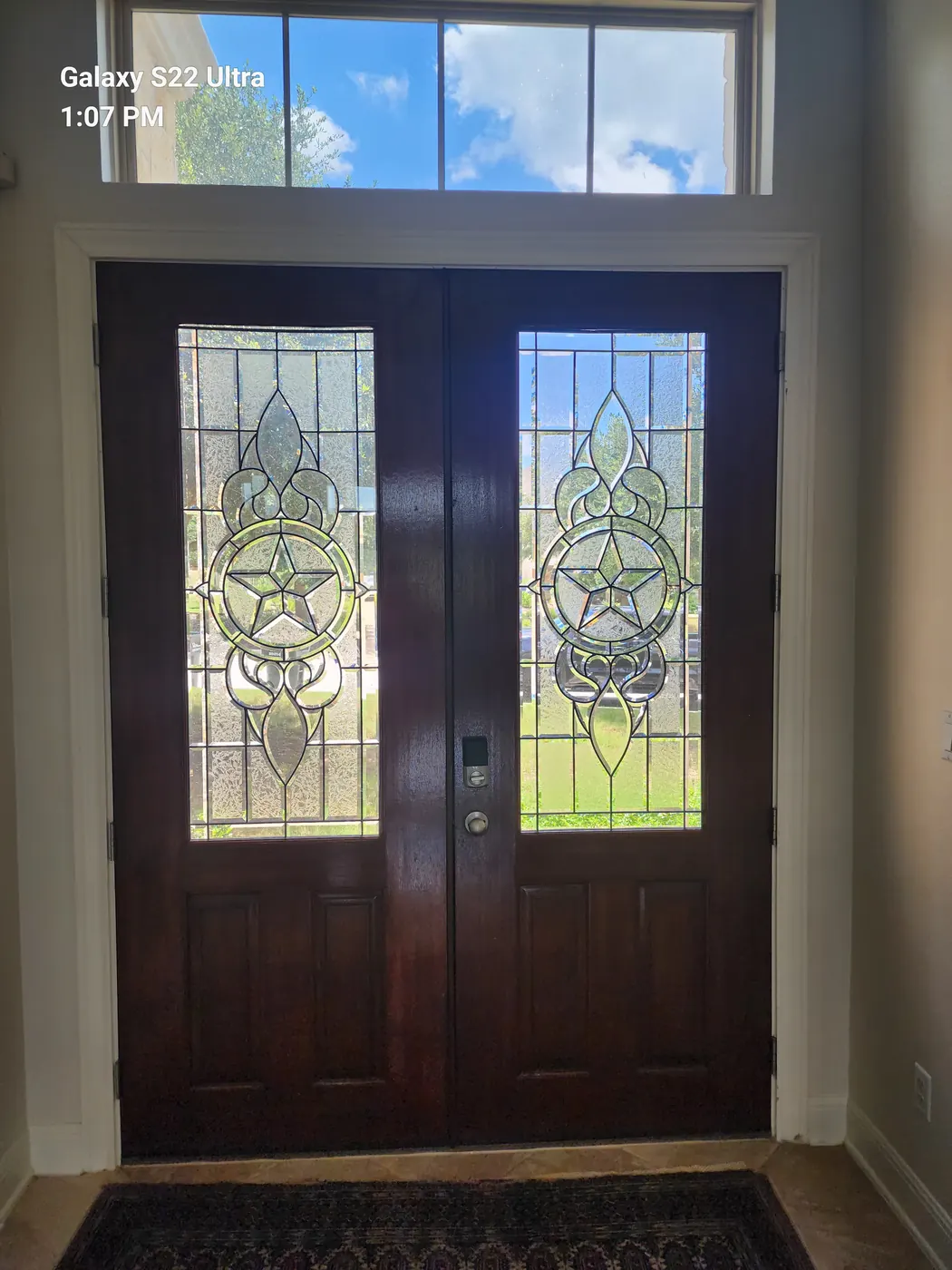 Close-up of the old leaded glass panels in the wood entry doors before replacement