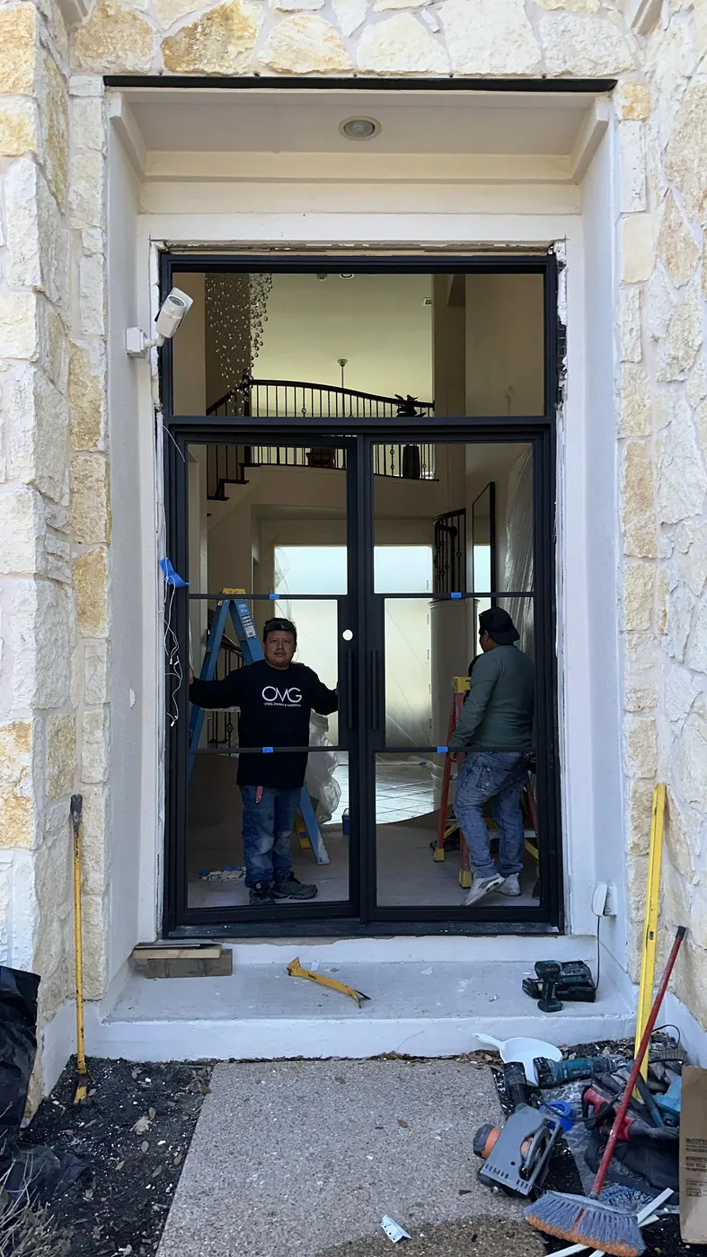 New black steel double door dry-fit in the opening during installation in Dripping Springs