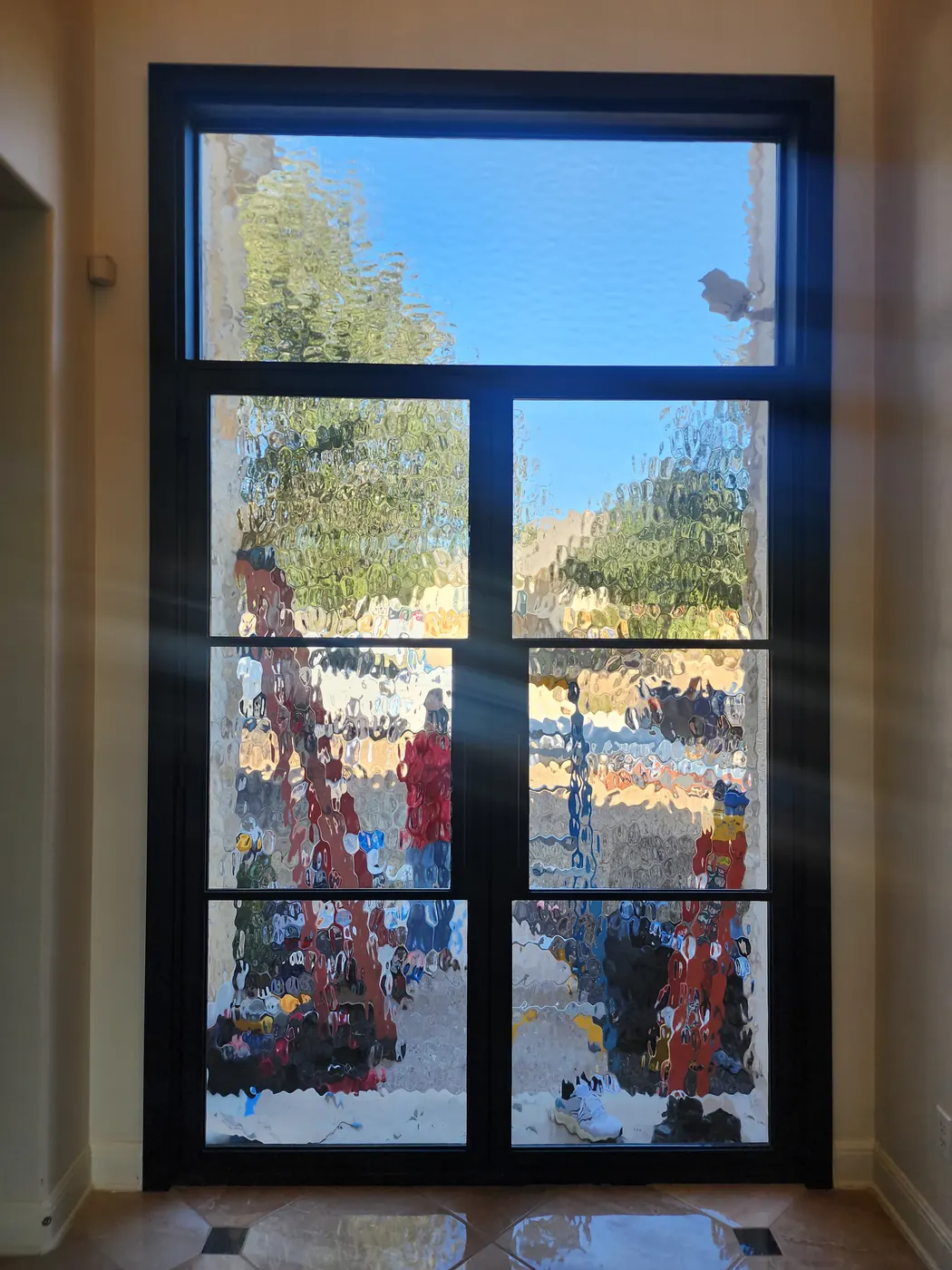 Interior view of the new steel entry door and transom in a Dripping Springs home