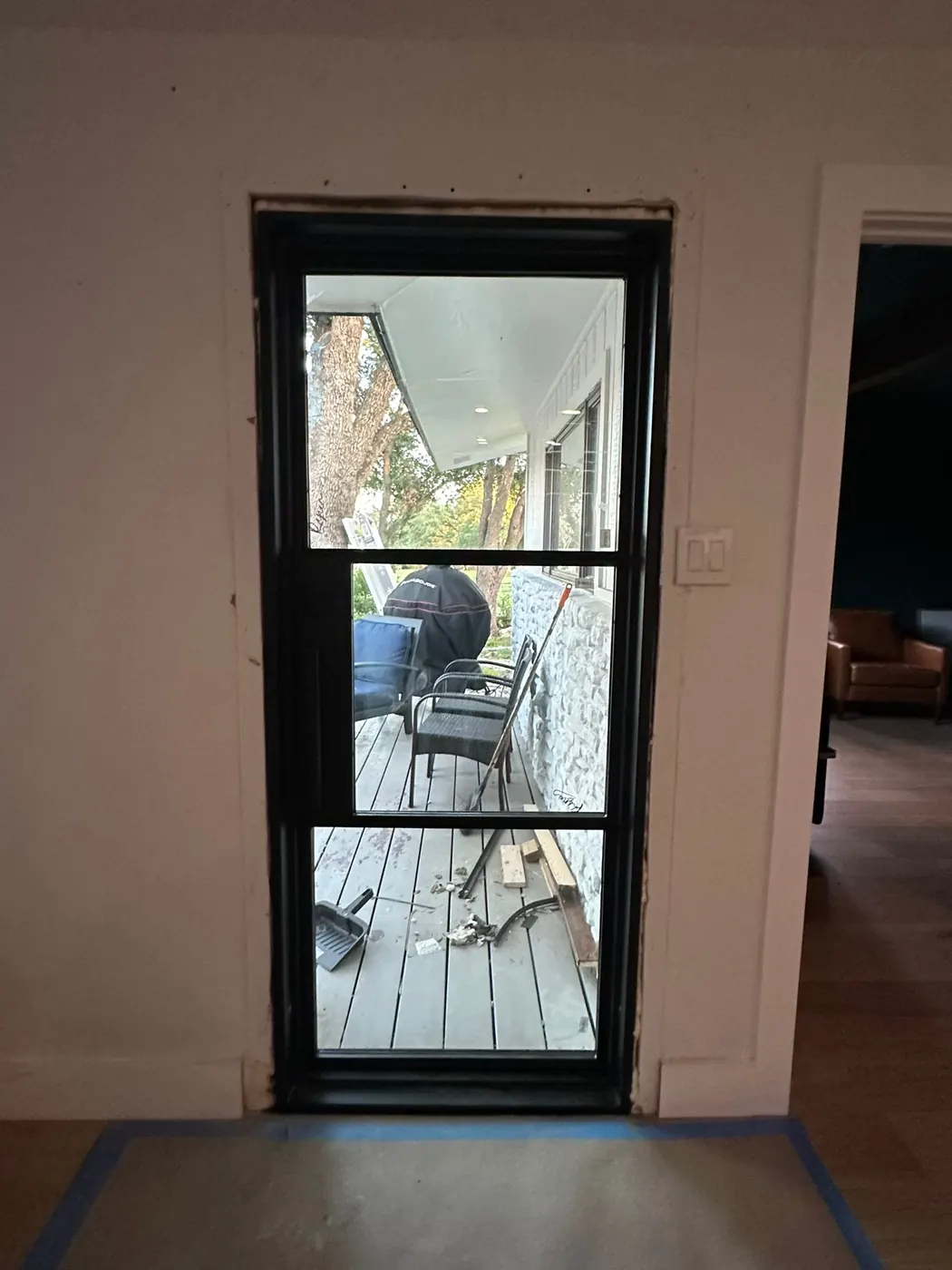 Interior view of a black steel single patio door installed in a Lakeway home