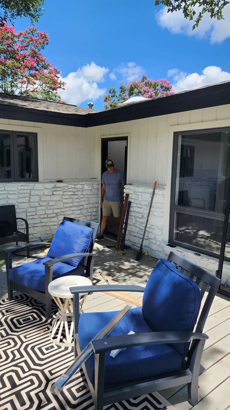 Covered patio of a Lakeway home before the steel patio door installation