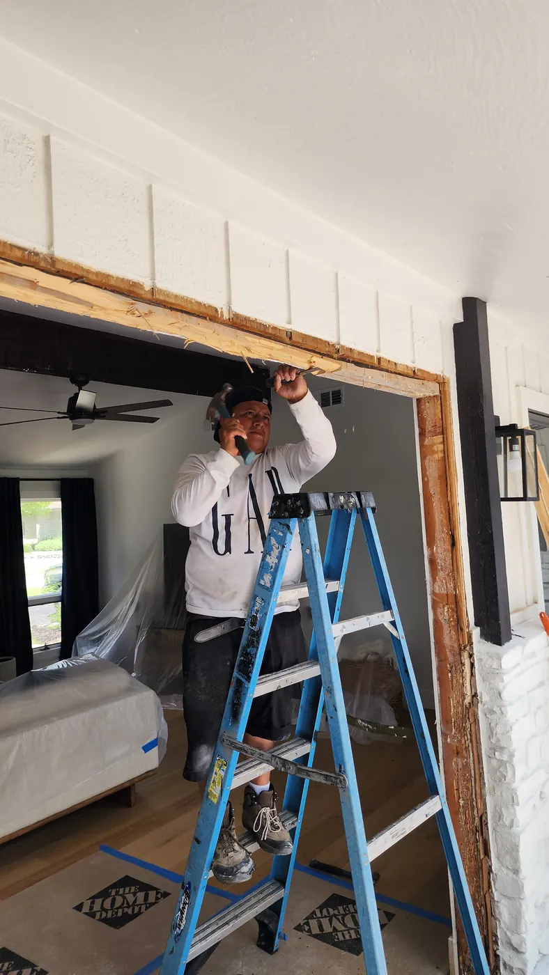 Steel door installation in progress on the rear porch of a Lakeway property