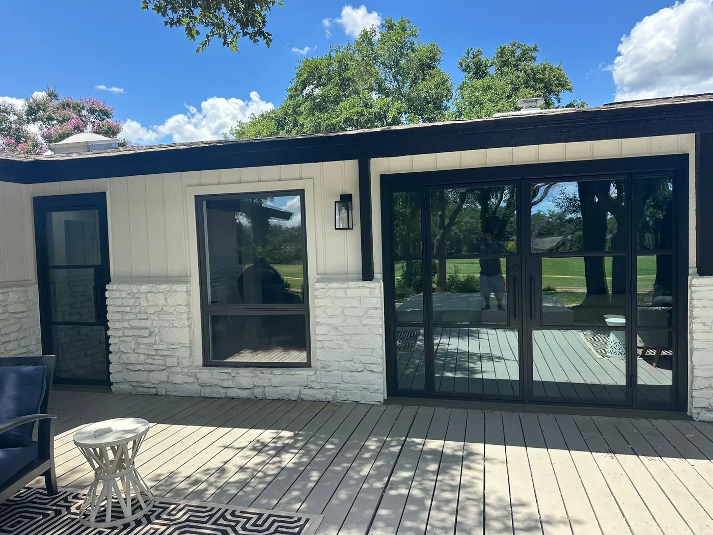 Black steel patio door wall installed across the back of a Lakeway home facing a golf course