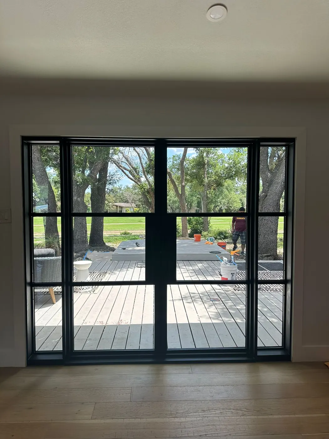 Living room of a Lakeway home with new steel patio doors along the back wall