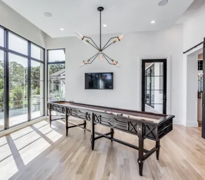 Modern open interior with black steel patio doors opening to the backyard